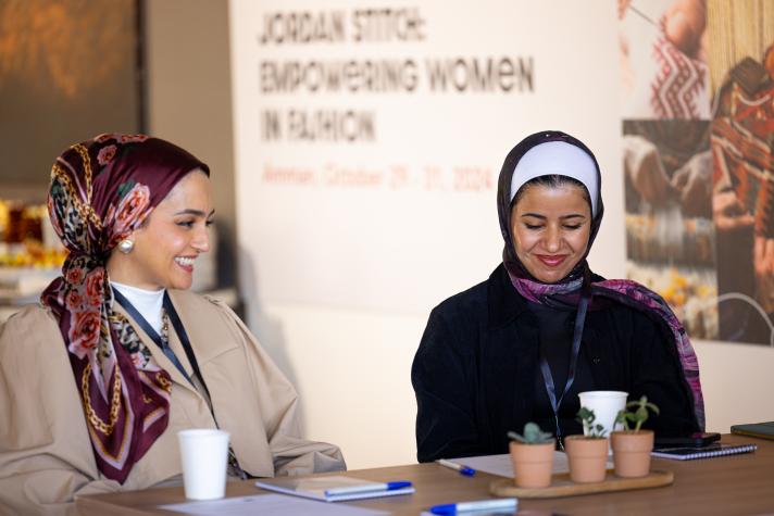 Two participants of Jordan Stitch talking and smiling.